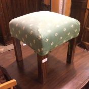 A 1930s/40s footstool, the upholstered top of floral design, on straight supports (39cm x 36cm x