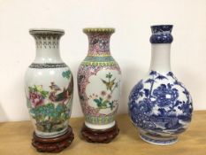A collection of 20thc. Chinese vases including a famille rose baluster shaped vase on stand, another