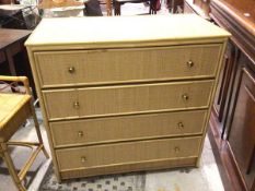 A modern cane and woven exterior chest of drawers fitted four long drawers on plinth base (93cm x