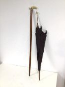 A mid 19thc malacca cane with ivory handle and white metal plaque depicting a Bird, with white metal