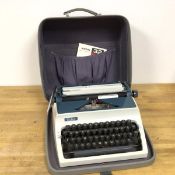 An Erika model 32 42 typewriter, with original travelling case and instructions (18cm x 39cm x
