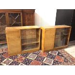 A pair of mid century teak side cabinets, the rectangular tops above single drawer with shelved