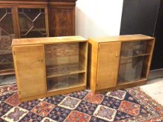 A pair of mid century teak side cabinets, the rectangular tops above single drawer with shelved