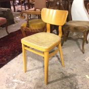 A late 20thc beech kitchen chair with upholstered seat, on moulded supports united by stretchers (