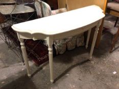 A contemporary white painted console table with undulating moulded top, fitted single frieze drawer,