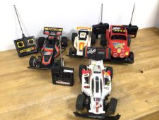 A collection of radio controlled cars including a Turbo Fox 8, a Turbo Beetle 8, a Powerblaster