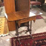 A late 19thc drop leaf mahogany sewing table, fitted single frieze drawer, on turned supports united