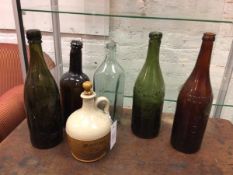 A collection of bottles including one possibly 18thc and three other bottles, one inscribed Ind Cope