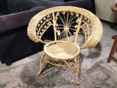 An Edwardian woven cane armchair, with hoop back above foliate designed back and arms (80cm x 85cm x