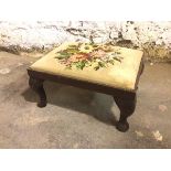 A 1920s/30s Georgian style footstool with grospoint padded top, on rectangular frame on cabriole