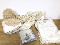 A collection of linens including napkins with Chinese inspired embroidery, place mats, small table