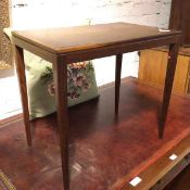 A teak occasional table, the rectangular top with chanelled frieze, on straight tapering supports (