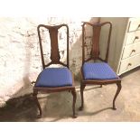 A pair of reproduction early 18thc style side chairs with dished top rail, with foliate carved