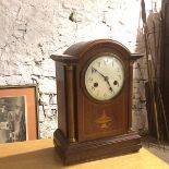 An Edwardian mantel clock of architectural form, with enamelled dial and arabic numerals (missing