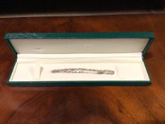 A bracelet, the nine uniform kz stones claw set between 9ct white gold, crossover links, stamped