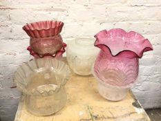 A group of early 20thc glass shades of various shapes and designs, some with rose coloured glass (