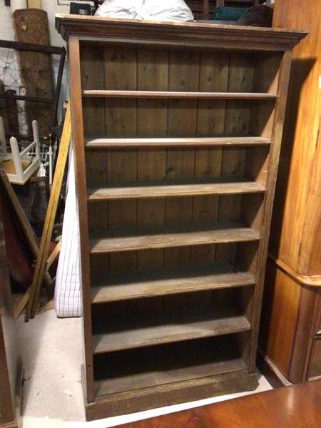 A 1930s/40s open bookcase with moulded cornice, fitted seven shelves, on plinth base (135cm x