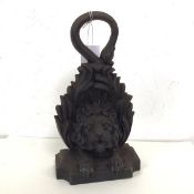 A cast iron doorstop with lion mask on base (30cm)