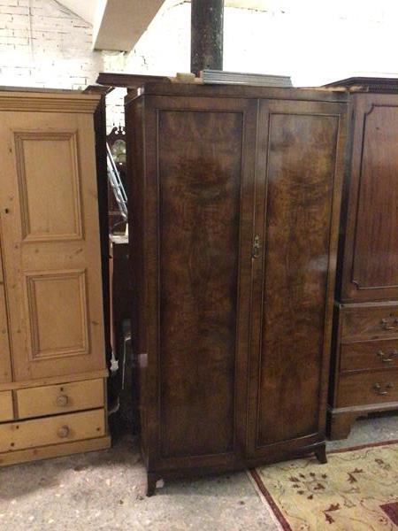 A 1940s mahogany wardrobe, fitted twin panel doors, on moulded supports (cornice a/f) (184cm x