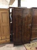 A 1940s mahogany wardrobe, fitted twin panel doors, on moulded supports (cornice a/f) (184cm x