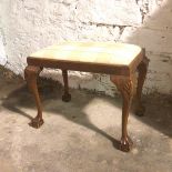 A reproduction 1930s/40s Georgian style footstool, the cabriole supports with shell carving to