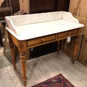 A Victorian washstand, the marble top with three quarter gallery above two frieze drawers, on turned