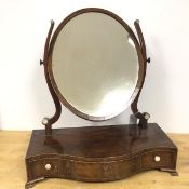 A 19thc mahogany dressing table mirror, the oval glass on curved supports, on serpentine front