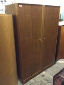 A mid century Meredew wardrobe, fitted two doors, one mirrored, with hanging rail and raised shelf