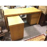 A modern desk with rectangular top, adjustable return and matching two drawer filing cabinet on