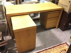 A modern desk with rectangular top, adjustable return and matching two drawer filing cabinet on