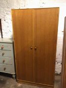A mid century teak wardrobe, fitted two doors, one with mirror to interior, on plinth base (176cm