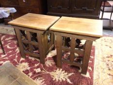 A pair of oak Gothic style side tables, with rectangular tops above pierced fronts and sides, on