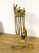 A gilt metal companion set with poker, shovel, brush and tongs along with an additional pair of