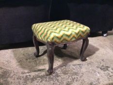 A 1920s/30s footstool with later upholstered top, with serpentine sides, on cabriole supports (