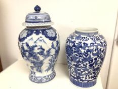 A large Chinese blue and white baluster lidded jar, decorated with Mountain Landscape and a Fruit