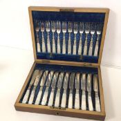 A near complete set of Edwardian mother of pearl handled fruit knives and forks, with one fish knife
