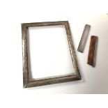 A Birmingham silver photograph frame (internal: 17cm x 13cm) and a Birmingham silver comb with