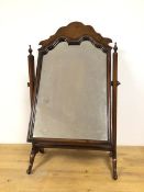 A 1930s/40s Queen Anne style walnut dressing table mirror on hinged supports with urn finials, on