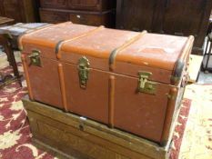 A vintage travelling trunk with a terracotta painted exterior, the interior with fitted tray (47cm x