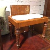 A Victorian mahogany bidet, the interior with undulating ceramic pan, on turned supports