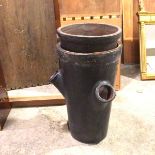 A terracotta inverted chimney pot, painted black with three apertures to side used as strawberry pot