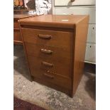 A mid century teak small chest of drawers fitted four drawers, top drawer bearing partial