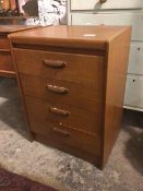 A mid century teak small chest of drawers fitted four drawers, top drawer bearing partial