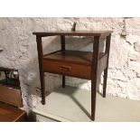 A mid century teak lamp table, the rectangular top above a lower tier fitted single drawer, on
