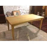 A contemporary oak farmhouse table with moulded edge on straight tapering supports (77cm x 179cm x