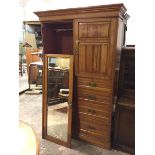 A late 19thc/early 20thc birch wardrobe with a mirror door, the interior with hanging space, with