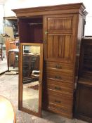A late 19thc/early 20thc birch wardrobe with a mirror door, the interior with hanging space, with