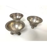 A near matching set of three white metal sorbet dishes with foliate decoration to rim, on ball