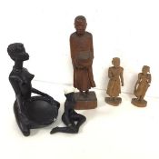 A carved wooden figure of a Monk with Jar (31cm), two other South East Asian carved figures and