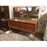 A mid century teak dressing table, the rectangular mirror over an arrangement of four drawers, on
